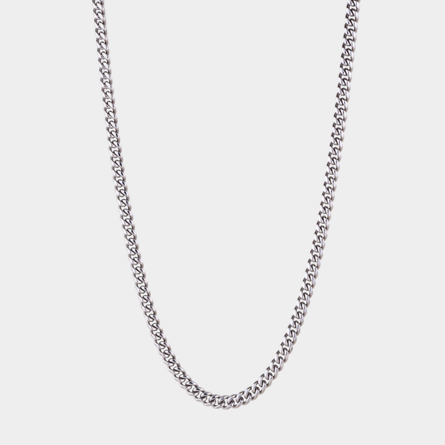 Silver chain necklace on a light gray background