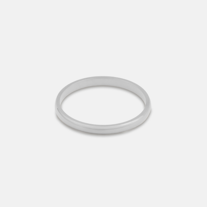 White steel band ring on a light grey background