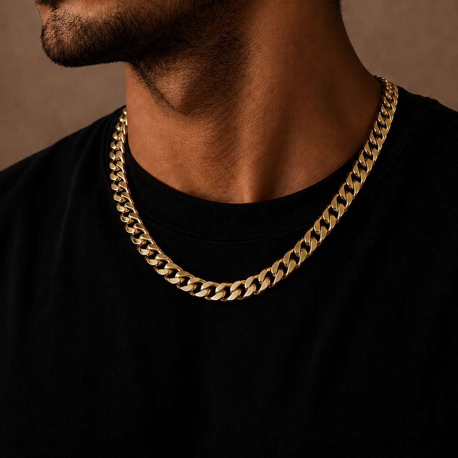 A close-up of a man wearing a thick gold Cuban link chain necklace over a black t-shirt, set against a warm brown textured background.