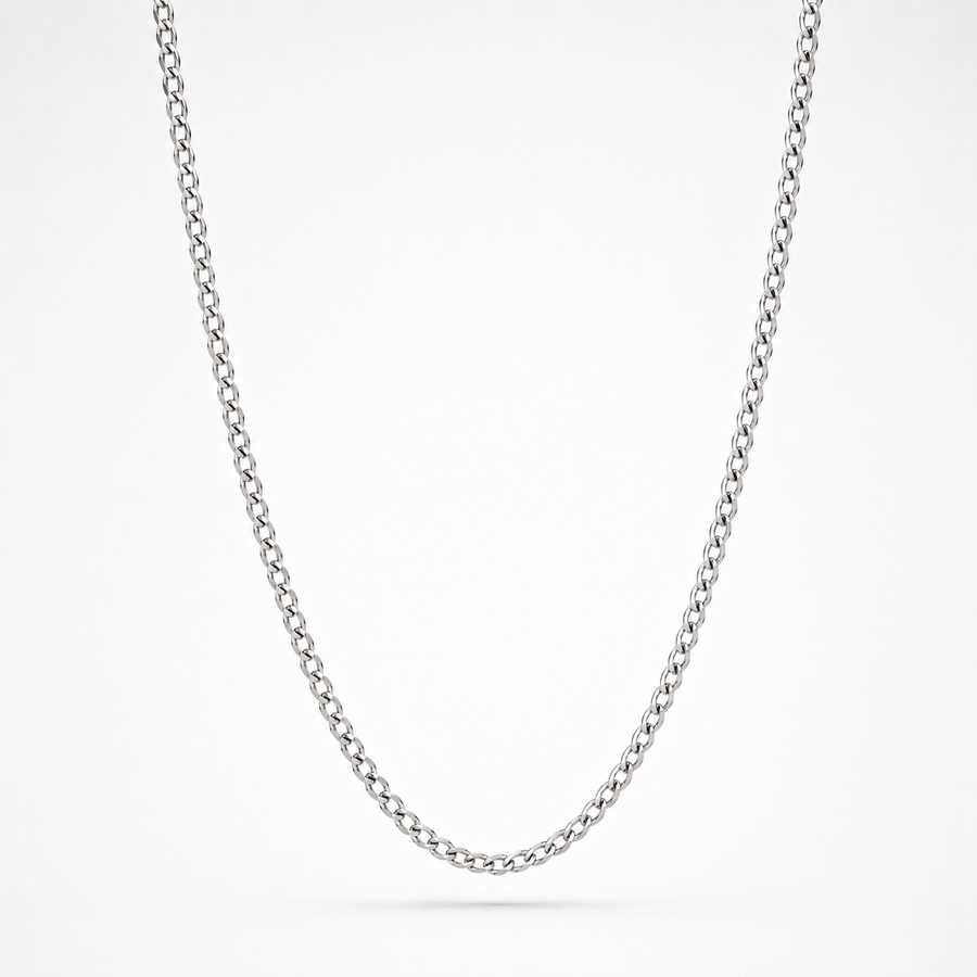 A classic silver curb chain necklace shown in a clean studio setting against a white background.