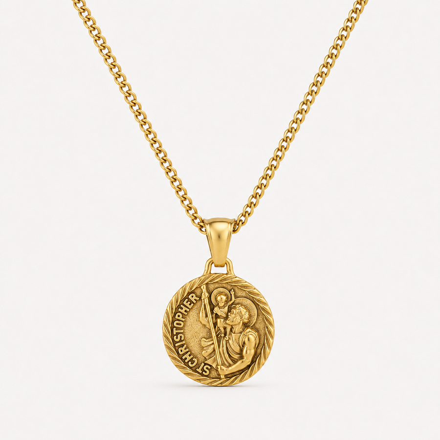 A gold pendant necklace featuring a circular Saint Christopher medal on a matching chain, set against a clean off-white background.