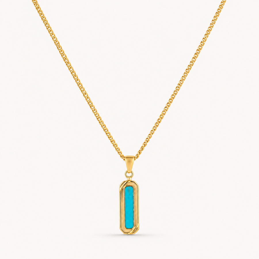A gold chain necklace with a vertical bar pendant featuring a bright turquoise center, set against a plain off-white background.
