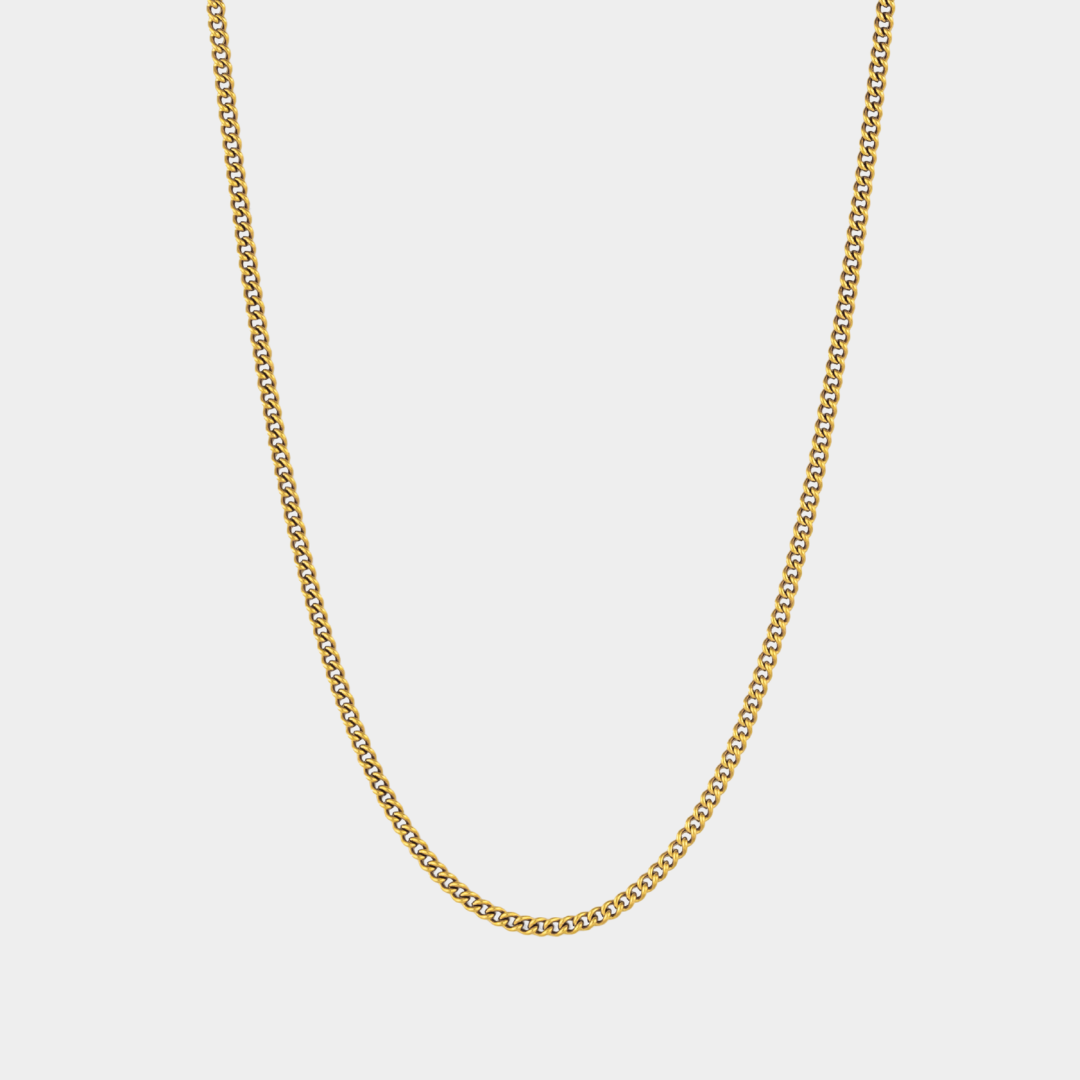 Gold chain necklace on a light gray background