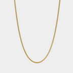 Gold chain necklace on a light gray background