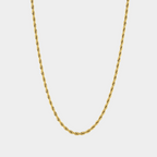 Gold chain necklace on a light gray background