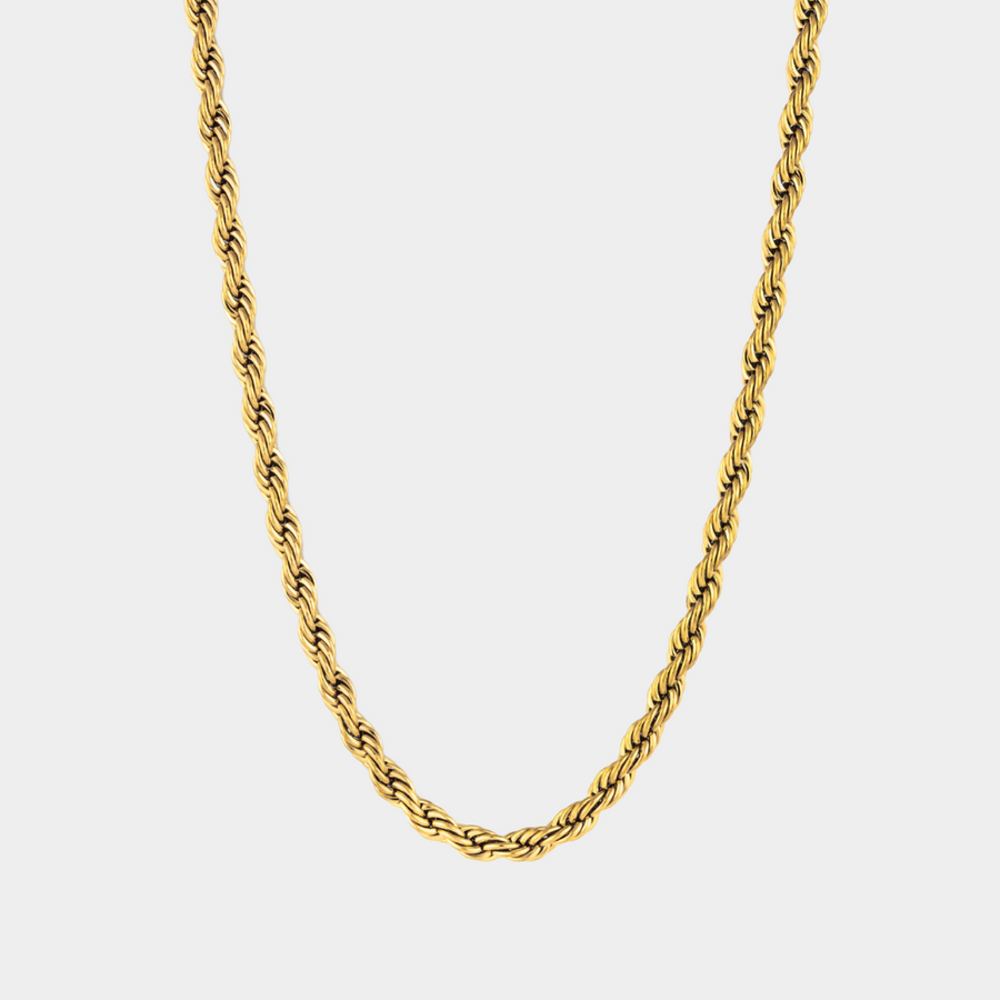 Gold rope chain necklace on a light gray background