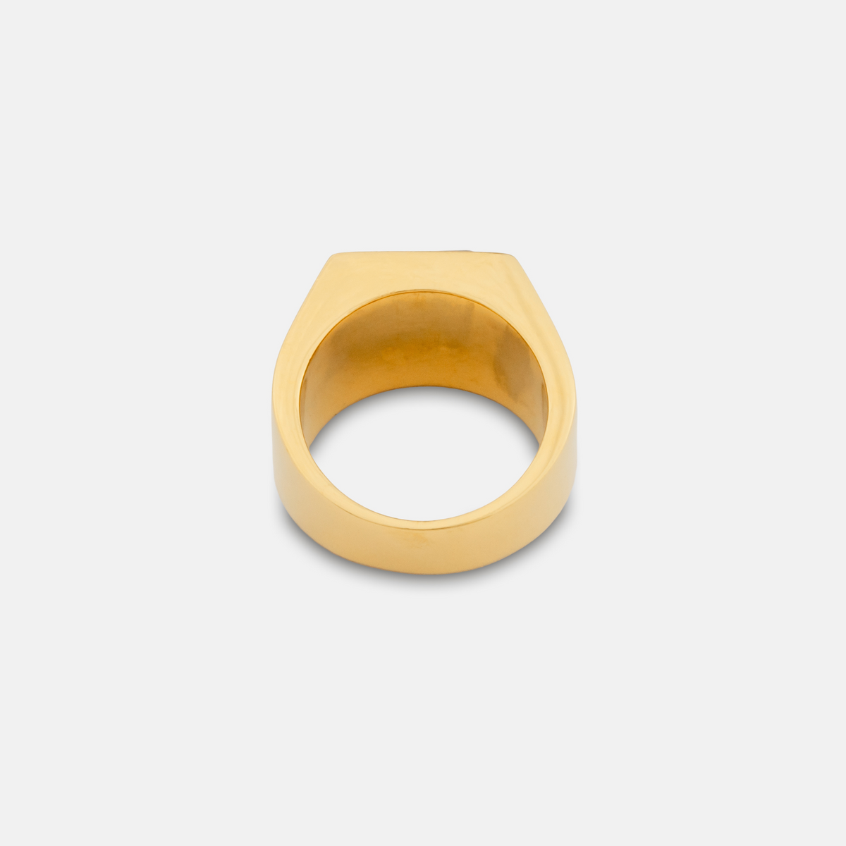 Gold ring on a light gray background