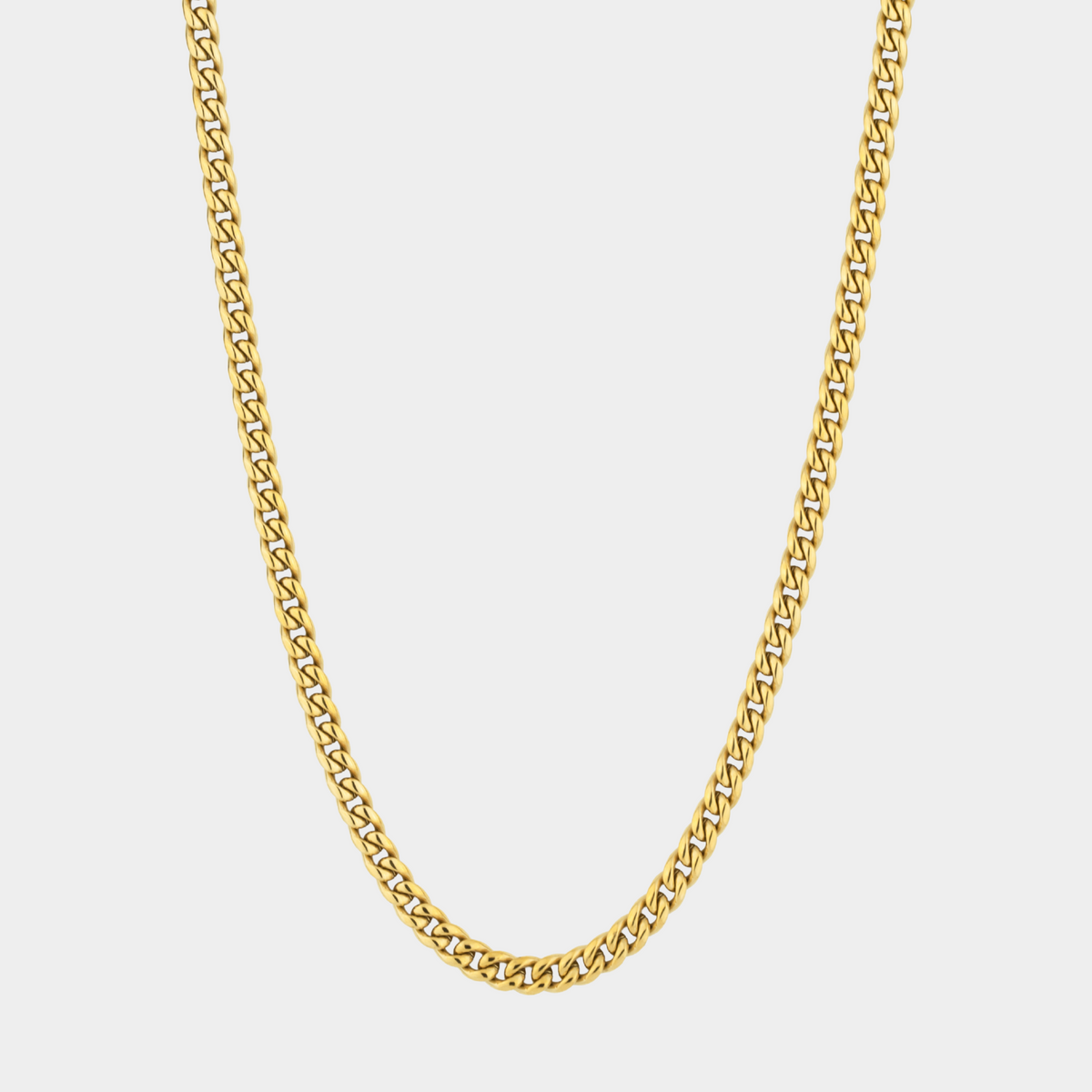 Gold chain necklace on a light gray background
