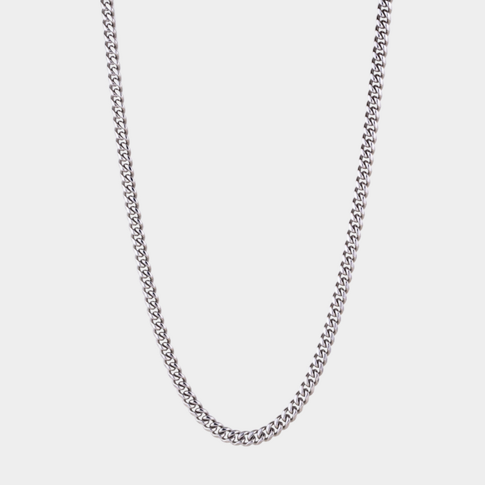 Silver chain necklace on a light gray background