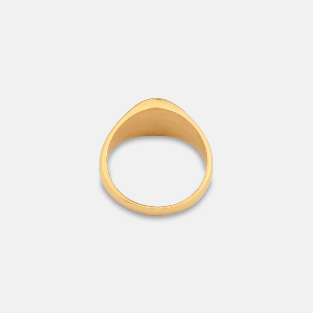 Gold ring on a light gray background