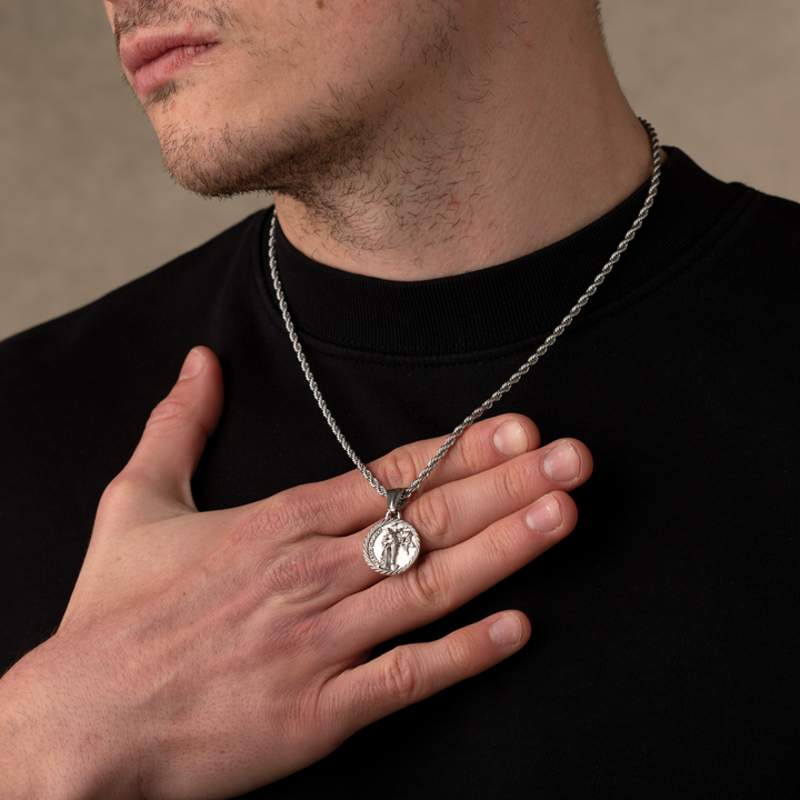 Man wearing a silver jesus christ necklace pendant