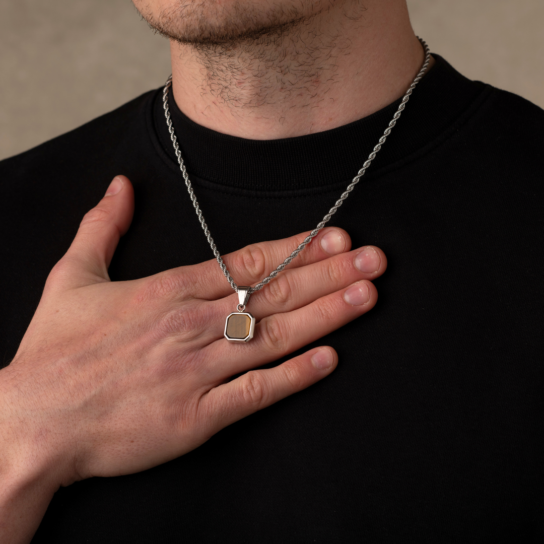Man wearing a silver tiger eye stone necklace pendant
