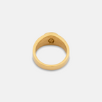 Gold ring with a logo on a light gray background