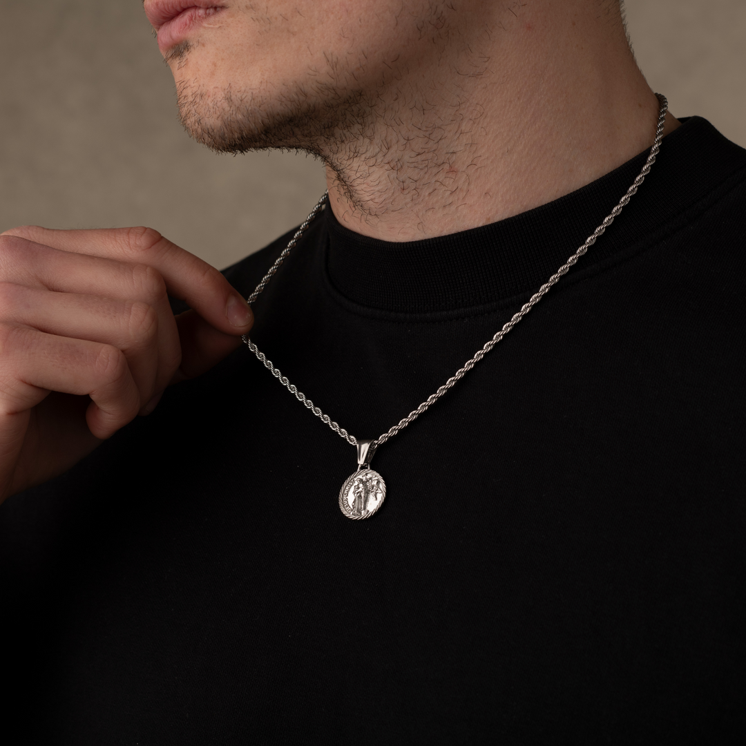 Man wearing a silver jesus christ necklace pendant