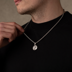 Man wearing a silver jesus christ necklace pendant