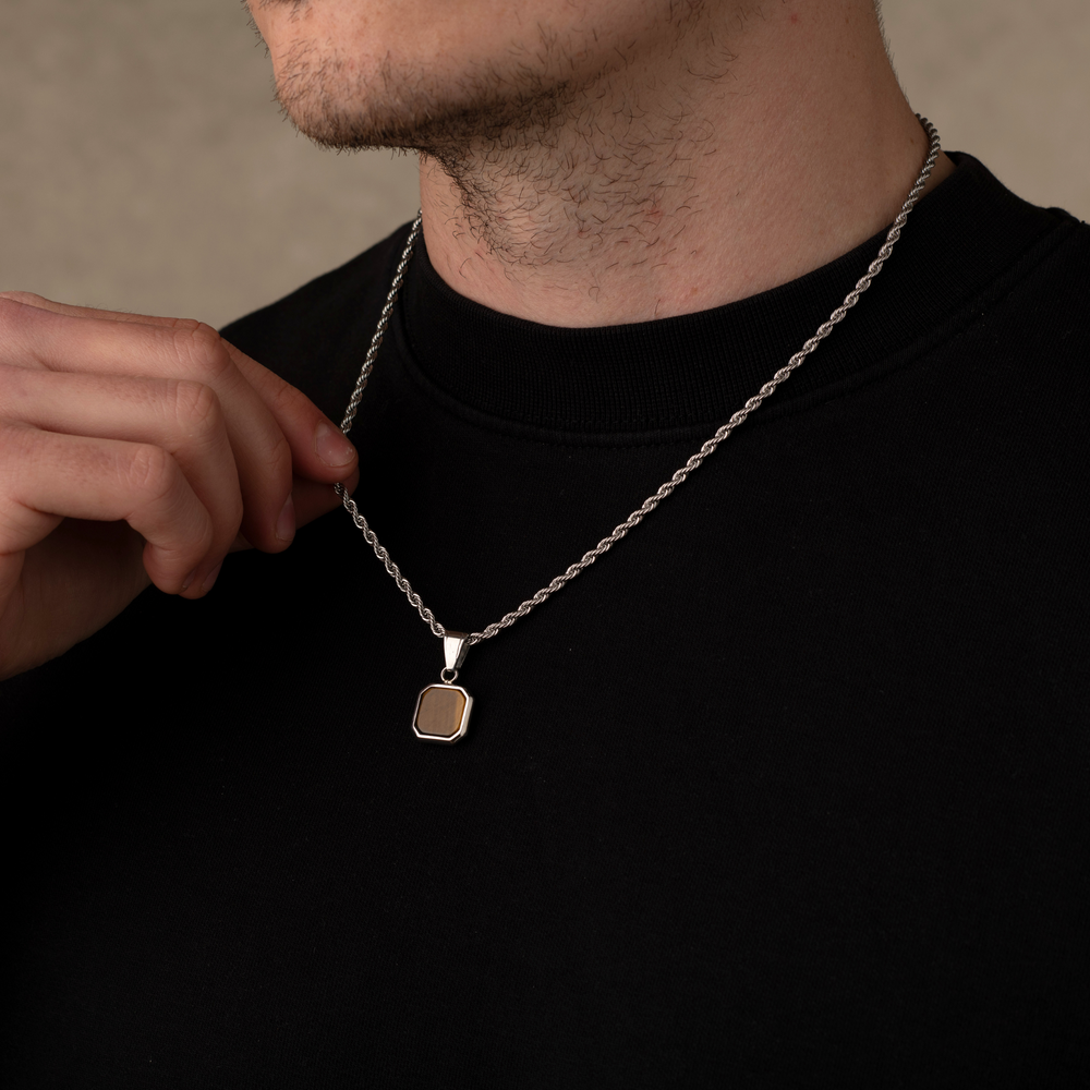 Man wearing a silver tiger eye stone necklace pendant