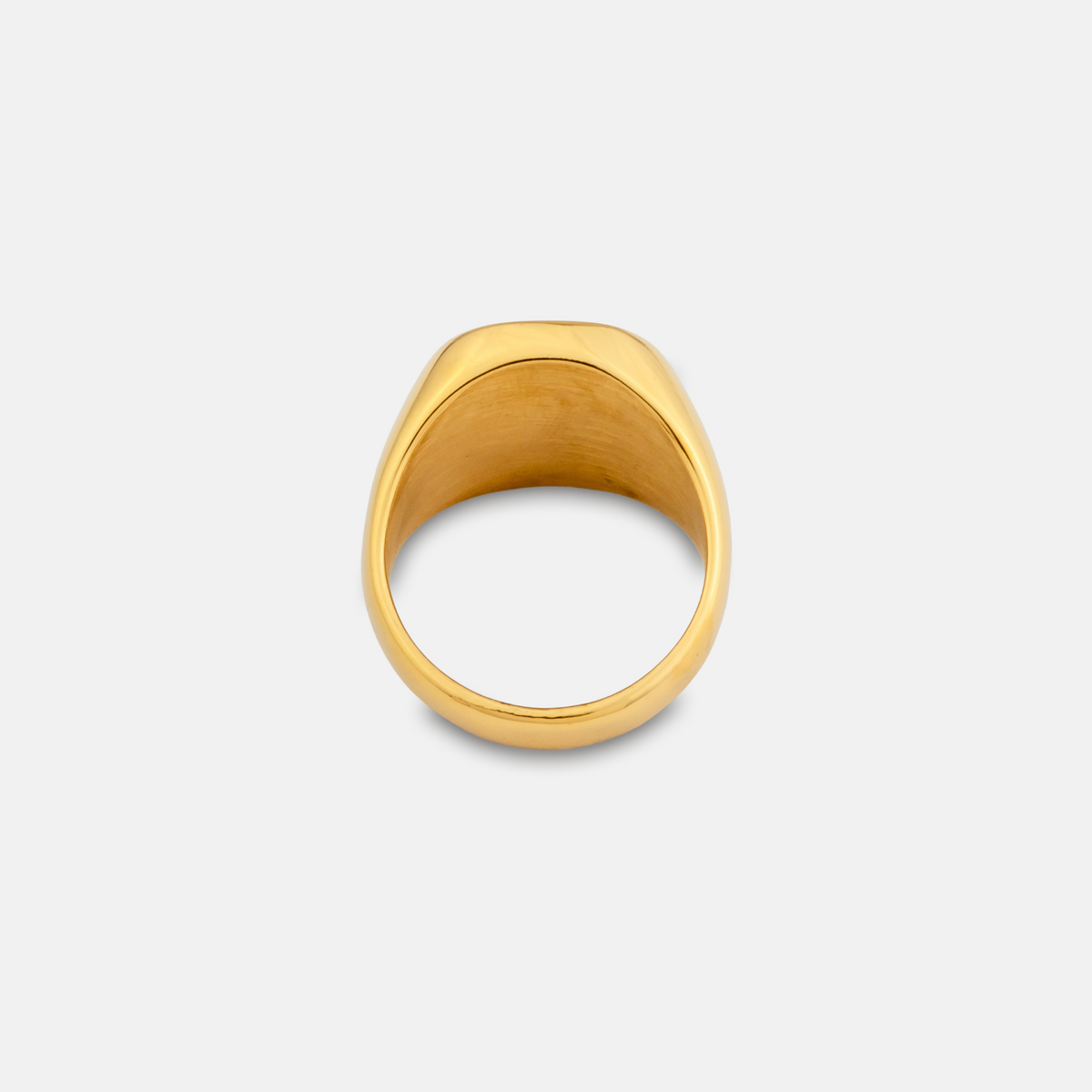 Gold ring on a light gray background