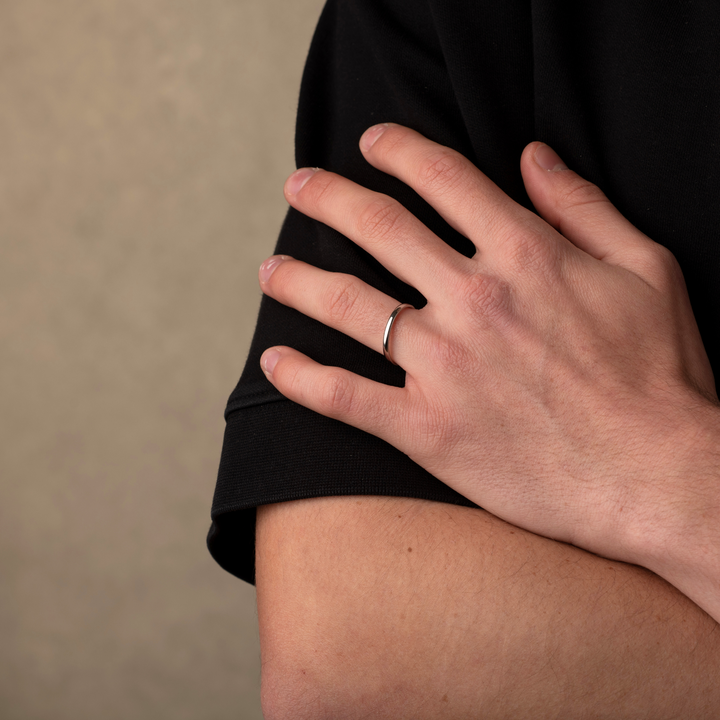 Man wearing a silver simple band ring 2mm