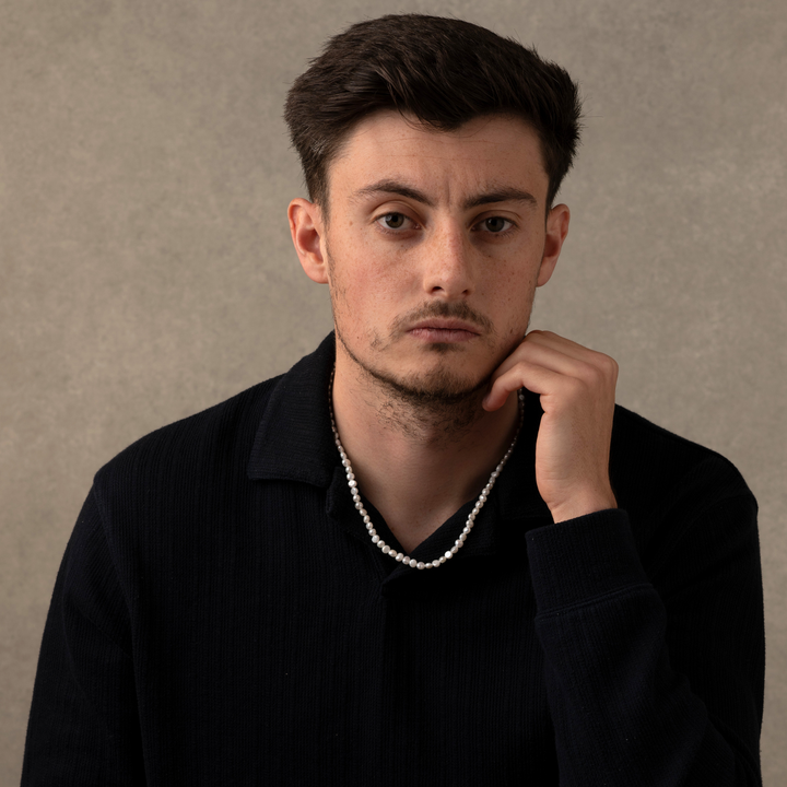 Man Wearing a Full Genuine Pearls Necklaces