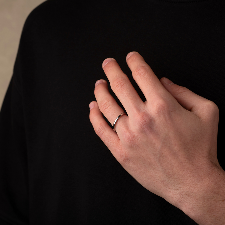 Man wearing a silver simple band ring 2mm