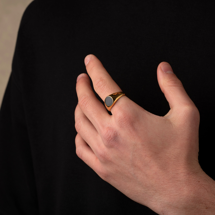 Someone wearing a gold Onyx Stone Signet Ring