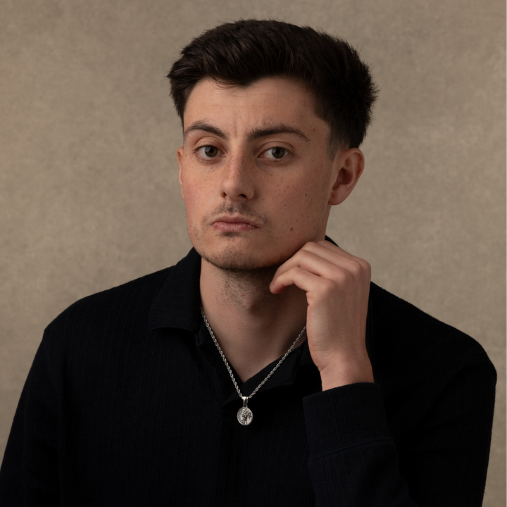 Man wearing a silver jesus christ necklace pendant