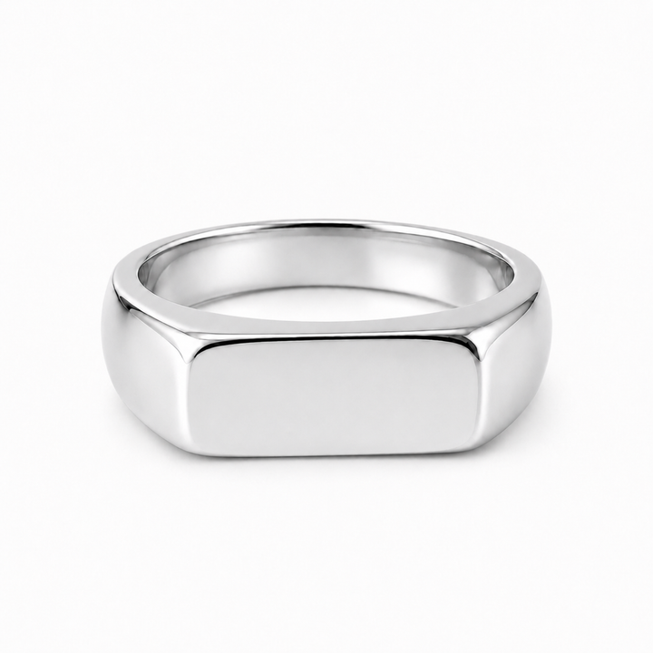 A polished silver signet ring with a flat, rectangular face and rounded shoulders, shown on a clean white background.