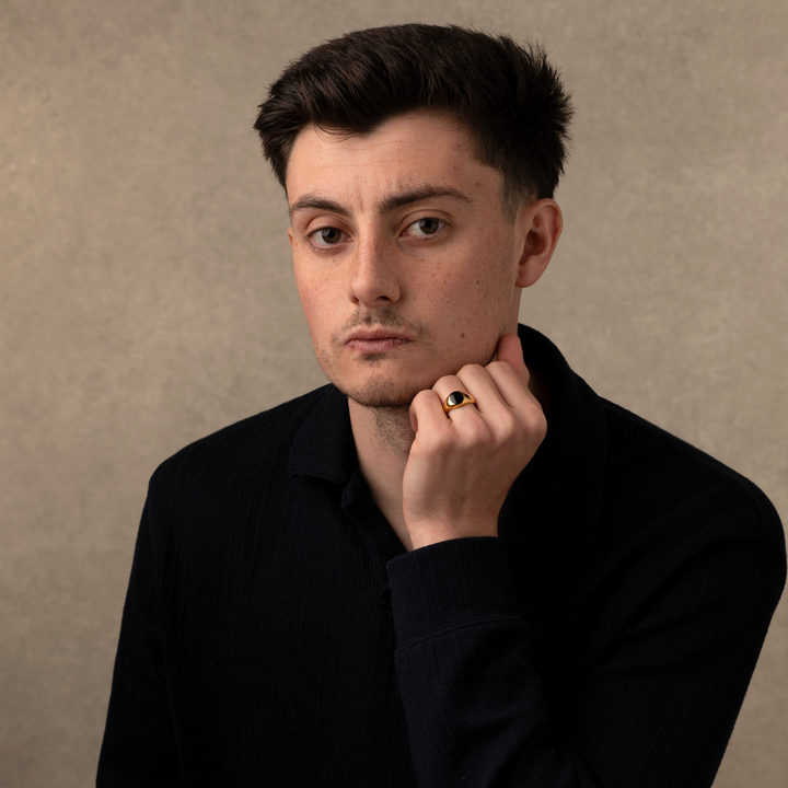 Someone wearing a gold Onyx Stone Signet Ring
