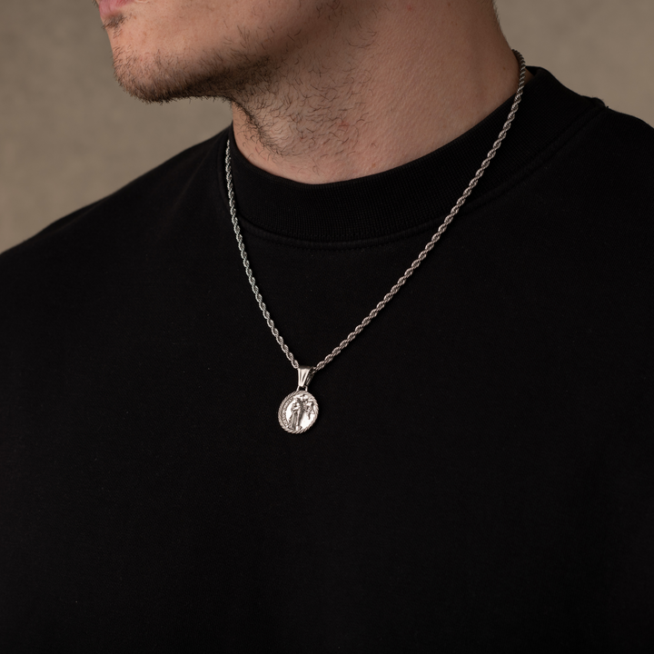 Man wearing a silver jesus christ necklace pendant