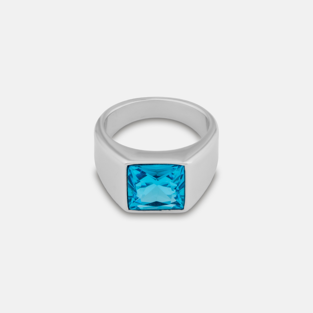 Silver blue stone signet ring on a white background