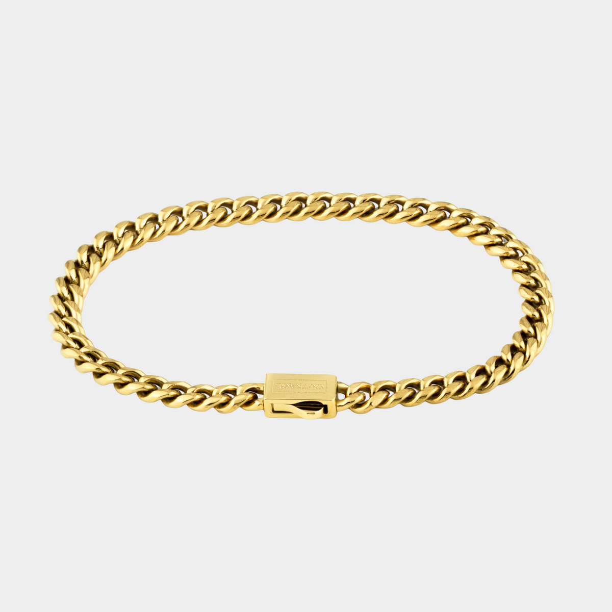 Gold chain bracelet on a light gray background