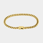 Gold chain bracelet on a light gray background