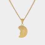 Gold necklace with a half-circle pendant on a light gray background