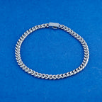 Silver chain bracelet on a blue background