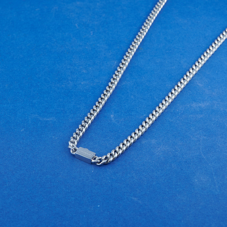 Silver chain necklace on a blue background
