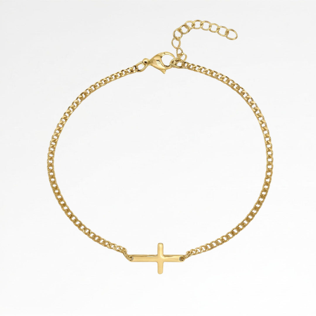 A gold-colored bracelet with a cross-shaped charm attached to it.