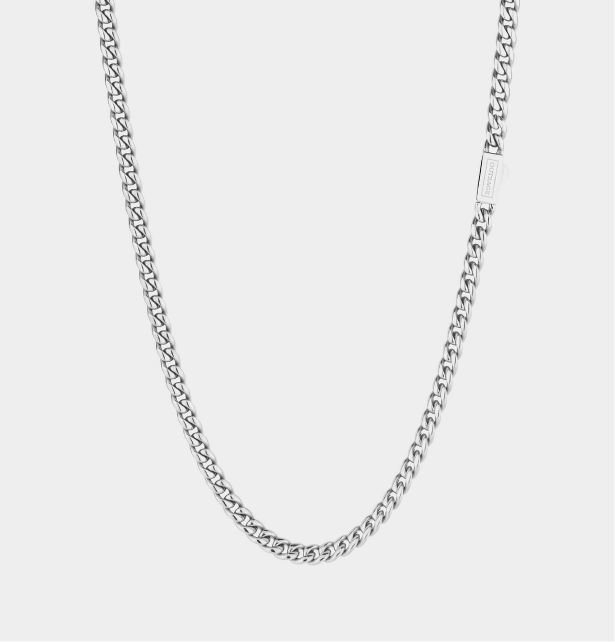 Silver chain necklace on a light gray background