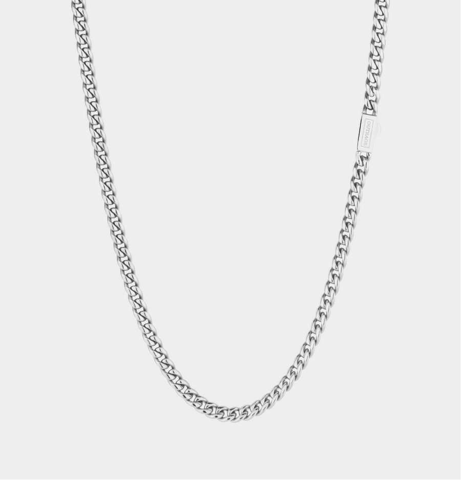 Silver chain necklace on a light gray background
