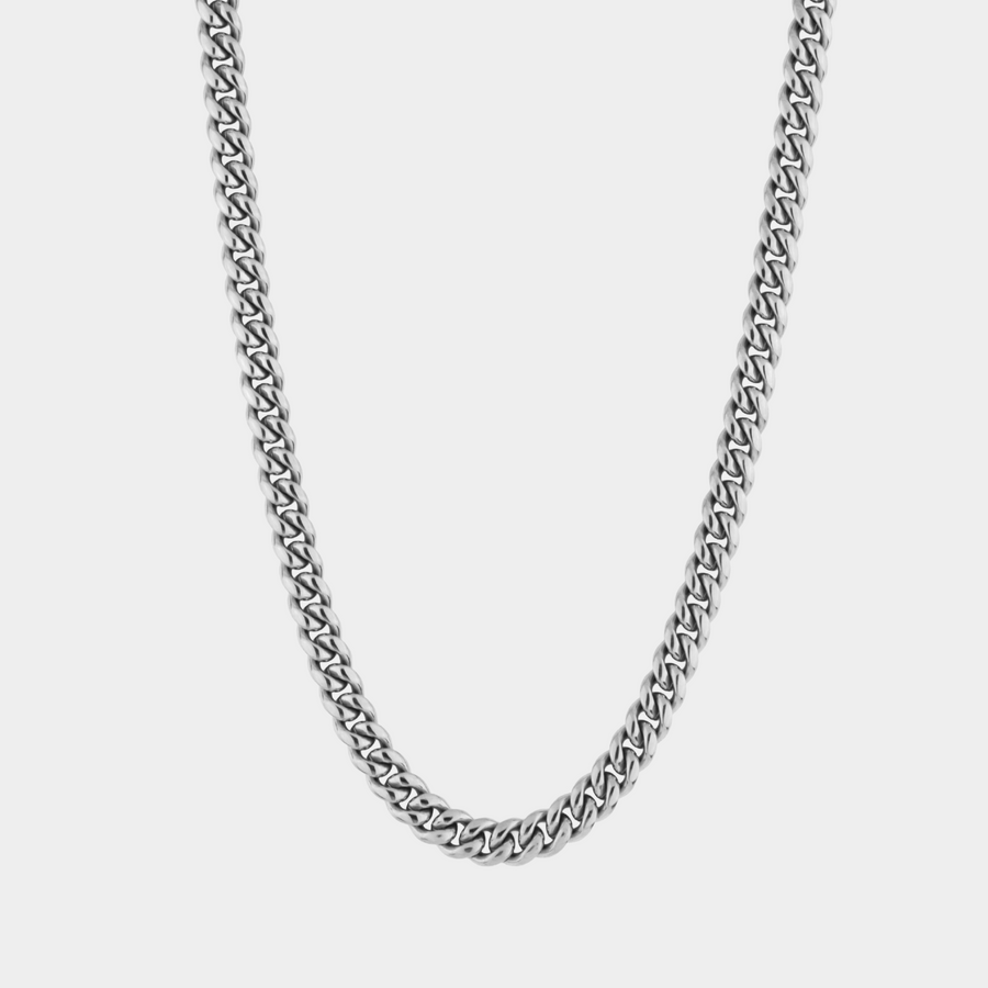 Silver chain necklace on a light gray background