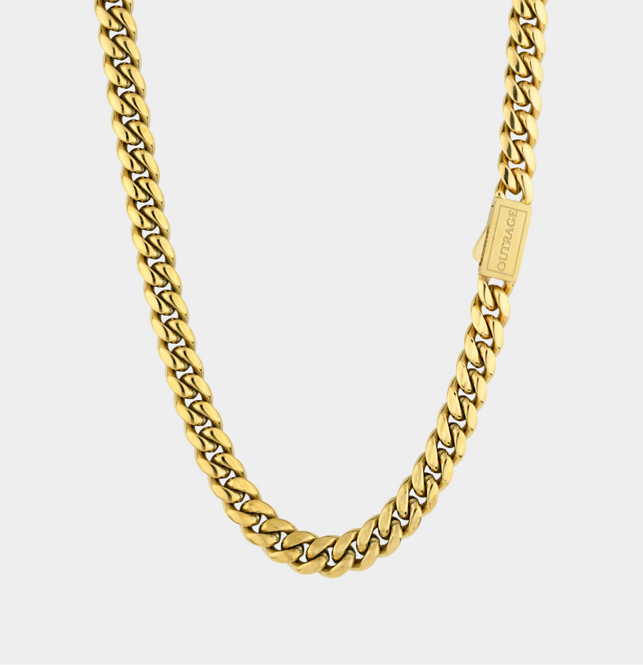Gold chain necklace on a light gray background