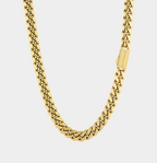 Gold chain necklace on a light gray background