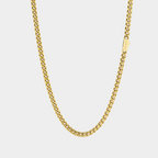 Gold chain necklace on a light gray background