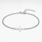 A silver-toned chain bracelet with a flat, polished cross charm in the center, displayed on a clean white background.