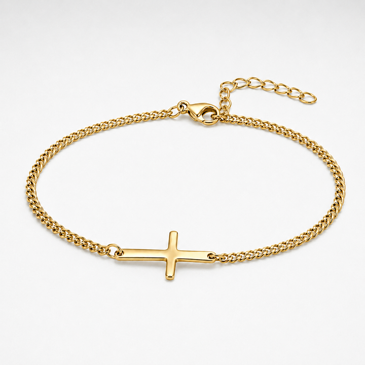 A gold chain bracelet with a polished cross charm, displayed on a clean white background.