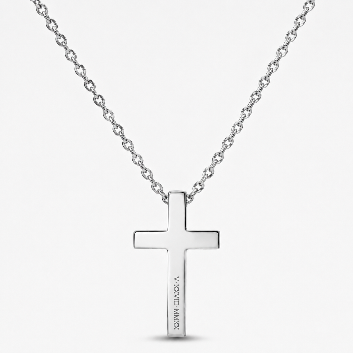 A silver cross pendant necklace with a polished finish and a fine link chain, shown against a light gray background. The cross features the engraved text 'JESUS IS MY LORD' vertically on the hanging arm.