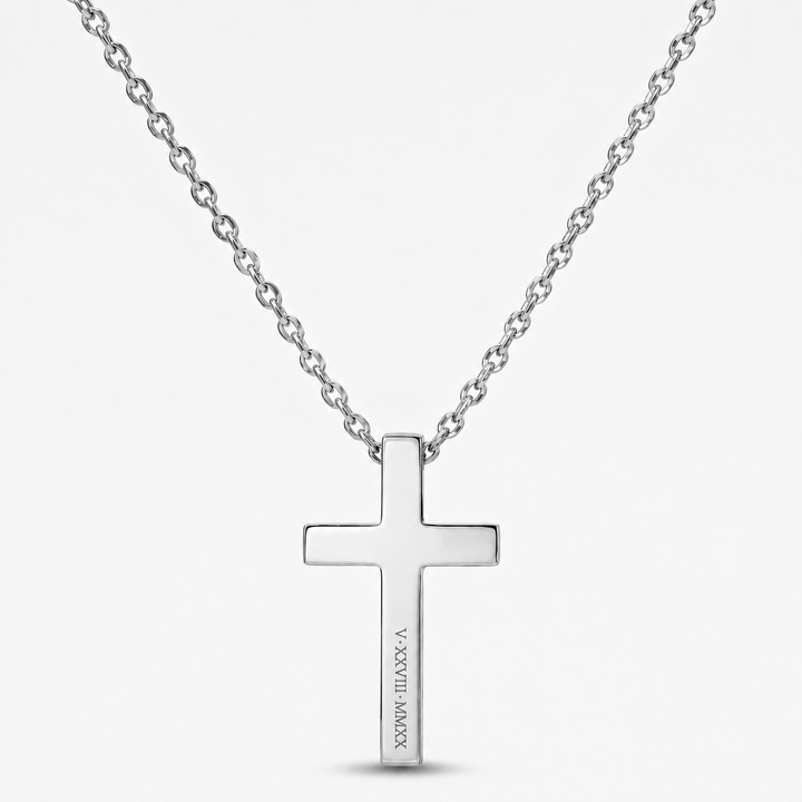 A silver cross pendant necklace with a polished finish and a fine link chain, shown against a light gray background. The cross features the engraved text 'JESUS IS MY LORD' vertically on the hanging arm.