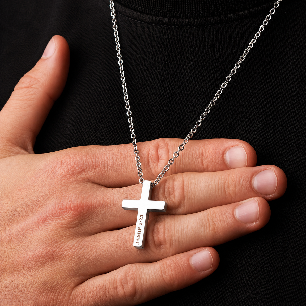 Man with hand under cross necklaces