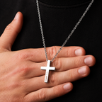 Man with hand under cross necklaces