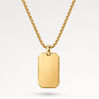A gold dog tag pendant necklace with a brushed finish and a matching gold chain, shown against a clean white background.