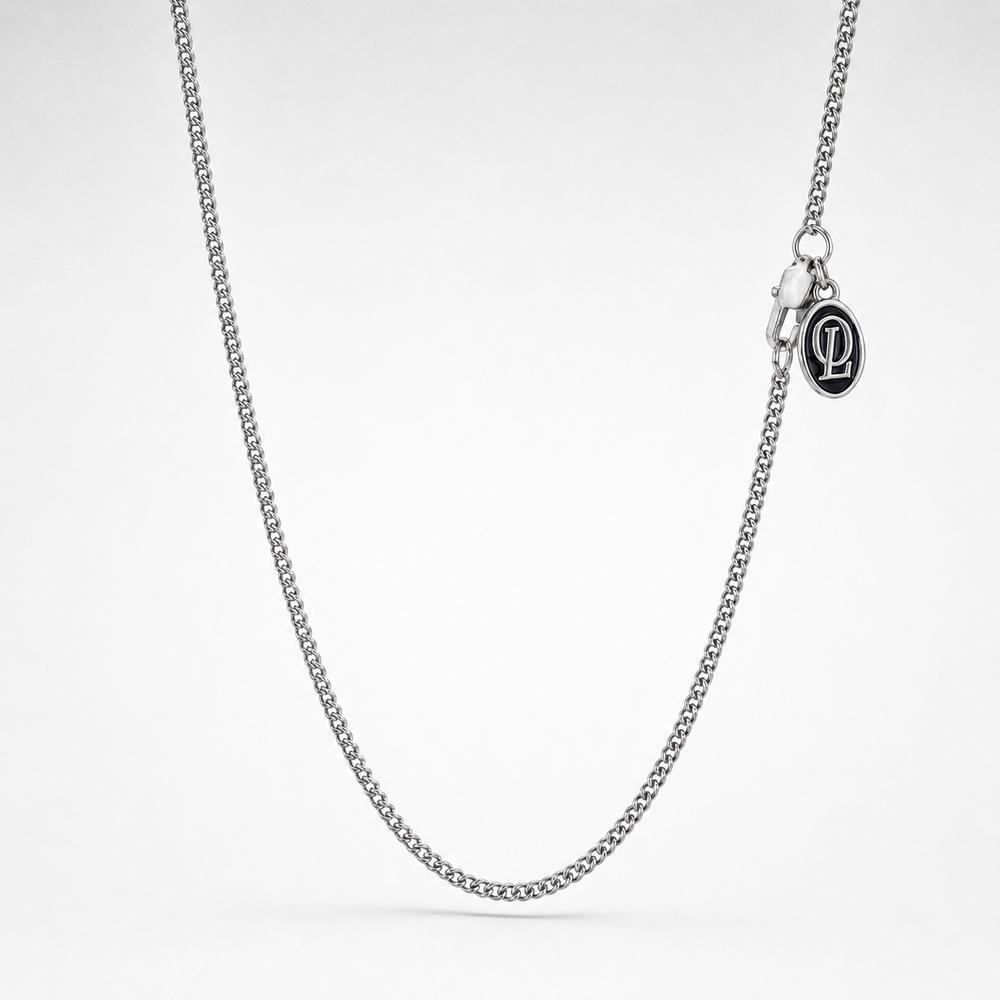 Silver chain necklace on a light gray background